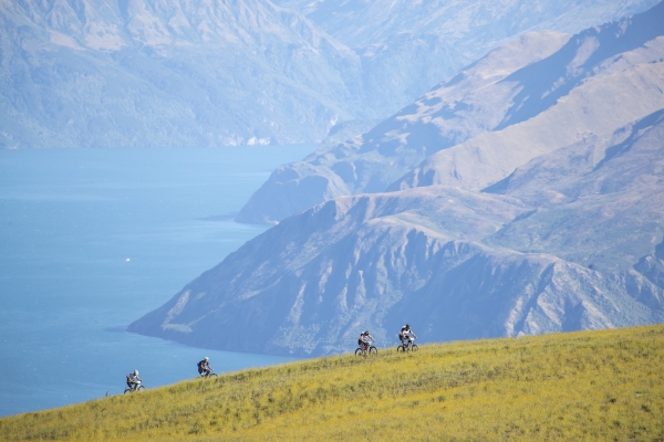 Competitors mountain biking high above Lake Wanaka in the 2019 Red Bull Defiance