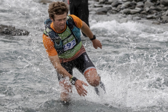 Hamish Elliott crosses the Otira River for Team OSM